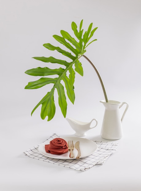 Interior image of food table with green plant over white wall background