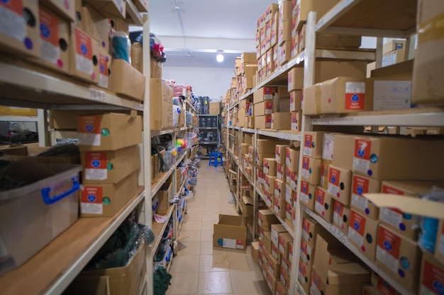 Interior of a industrial trim warehouse with many shelves with colorful button