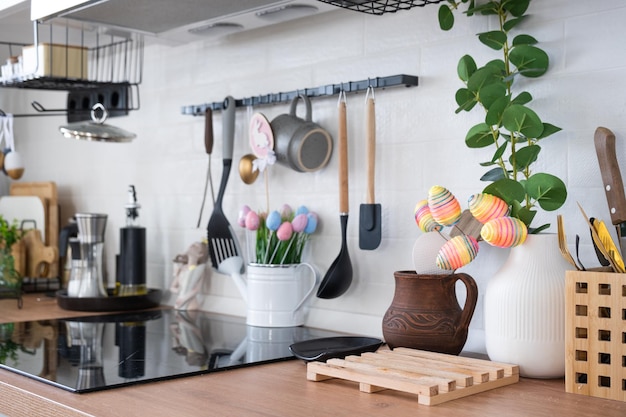 Interior of kitchen and details of decor of utensils with Easter decoration of colorful eggs in a loft style Festive interior of a country house