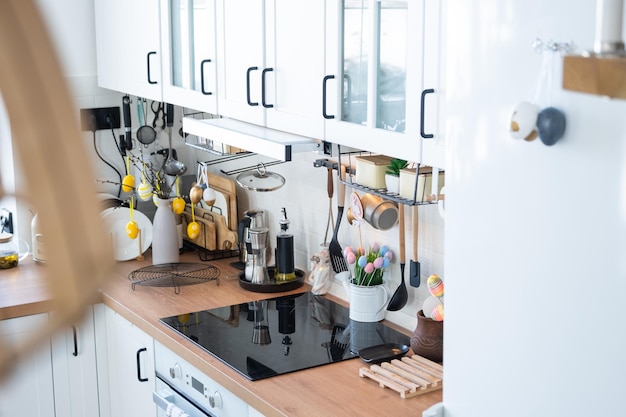 Interior of kitchen and details of decor of utensils with Easter decoration of colorful eggs in a loft style Festive interior of a country house