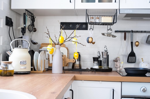 Interior of kitchen and details of decor of utensils with Easter decoration of colorful eggs in a loft style Festive interior of a country house