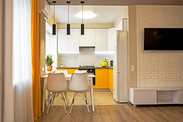 Interior of a modern apartment kitchen in shades of yellow