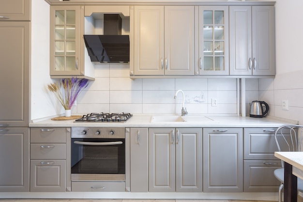 Interior of a modern beige and gray kitchen in a small smart apartment