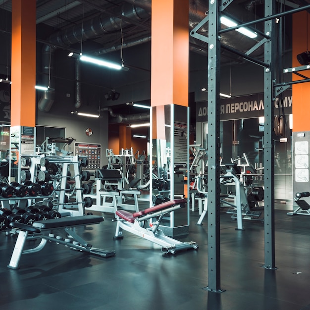 Interior of modern gym with equipments