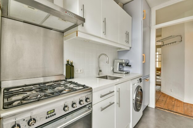 The interior of a modern kitchen in white design with appropriate appliances