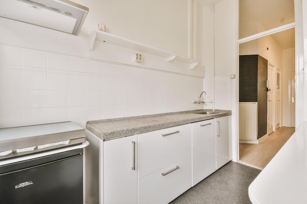 Interior of modern kitchen with white furniture