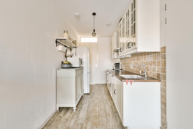 Interior of modern kitchen with white furniture