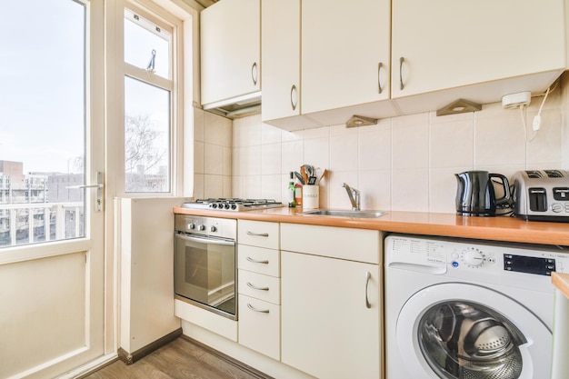 Interior of modern kitchen with white furniture