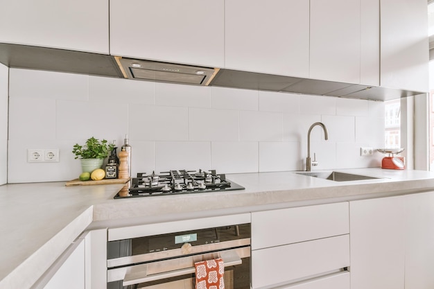 Interior of modern kitchen with white furniture