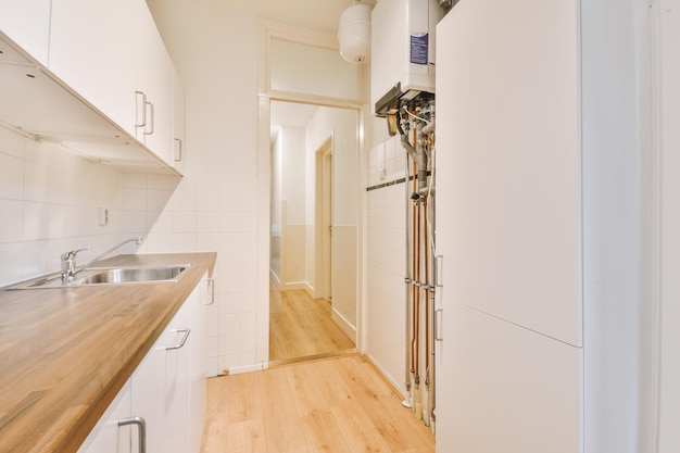 Interior of modern kitchen with white furniture