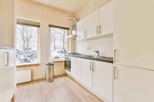 Interior of modern kitchen with white furniture