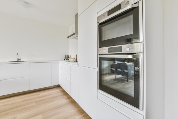 Interior of modern kitchen with white furniture