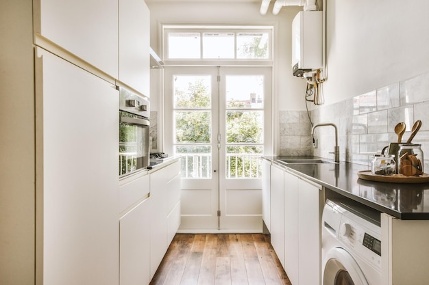 Interior of modern kitchen with white furniture