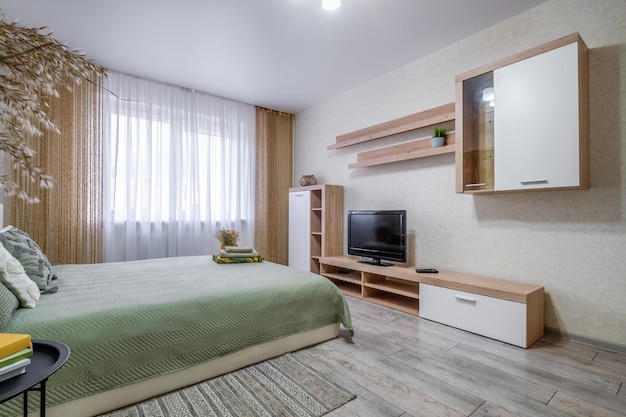 Interior of the modern luxure bedroom in studio apartments in light color style