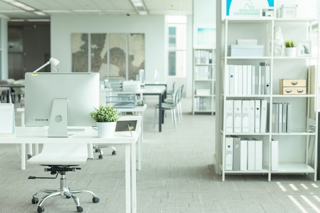 Interior of a modern office with computer and white furniture