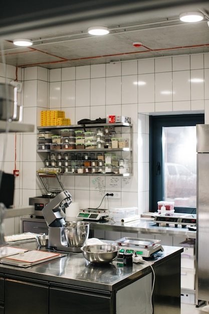 The interior of a modern spacious kitchen in a cafe or restaurant