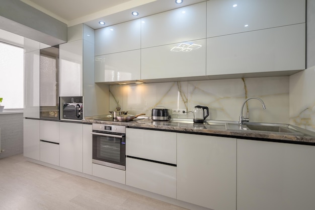 Interior of modern trendy white kitchen