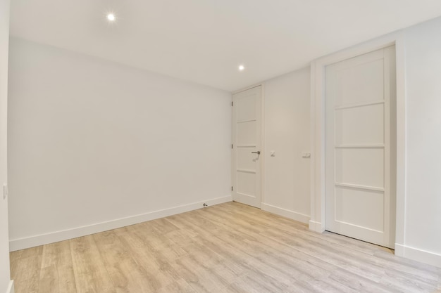 The interior of an open empty room in a studio apartment with a white decoration