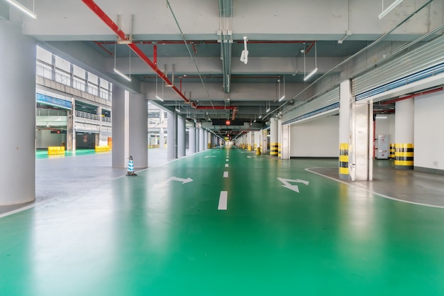 interior of parking garage with car and vacant parking lot in parking building