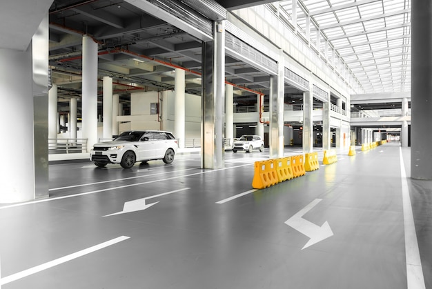 interior of parking garage with car and vacant parking lot in parking building