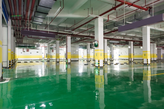 interior of parking garage with car and vacant parking lot in parking building