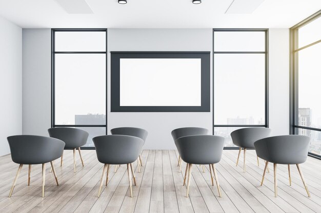 Interior of a presentation room with white chairs and blank screen