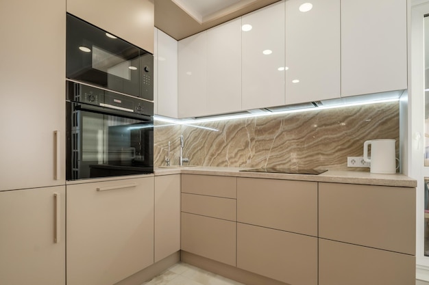 Interior of the small living equipped kitchen in studio apartments in minimalistic style