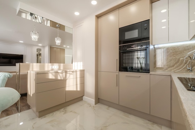 Interior of the small living equipped kitchen in studio apartments in minimalistic style