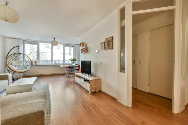 The interior of a spacious living room with a corner dvin opposite the TV