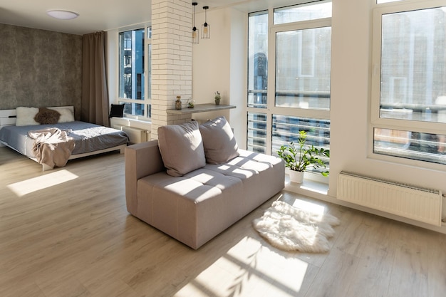 Interior of a studio apartment, wide room, bed in the foreground