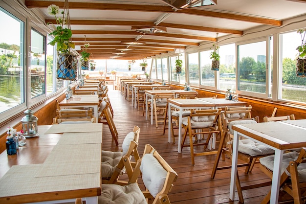 The interior of the urban river ship with a panoramic view of the urban landscape The concept of tourism recreation walking around the city rest in the city River transport