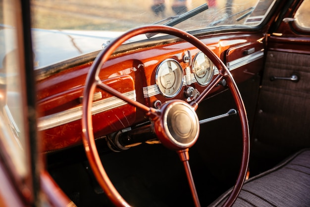 Interior of a vintage brown retro car. Driver's seat