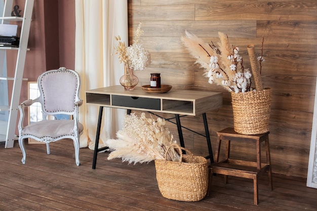 Interior workspace home with in brown tones with pampas grass and table