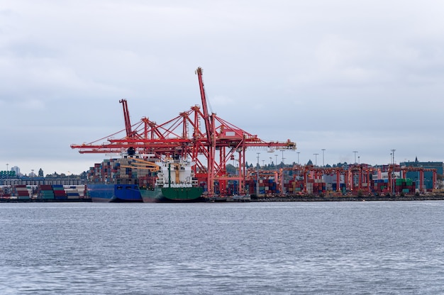 International cargo ship with containers cargo and gantry cranes on commercial port