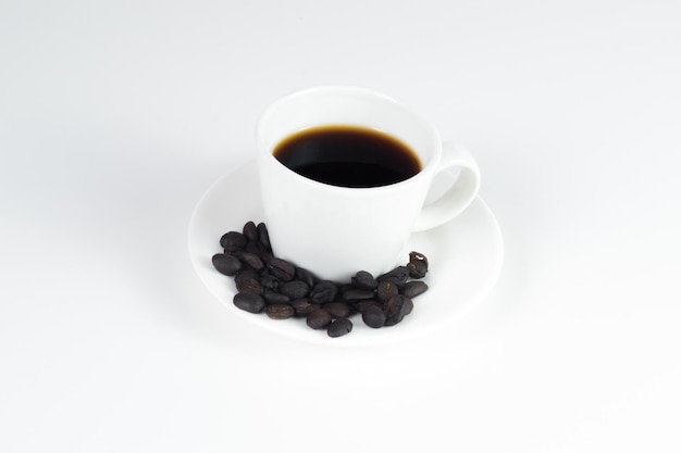 International coffee day traditional colombian drink closeup of a mug of coffee with a white background and roasted coffee with copy space