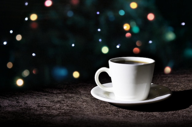 International coffee day traditional colombian drink coffee mug with lights in the background closeup