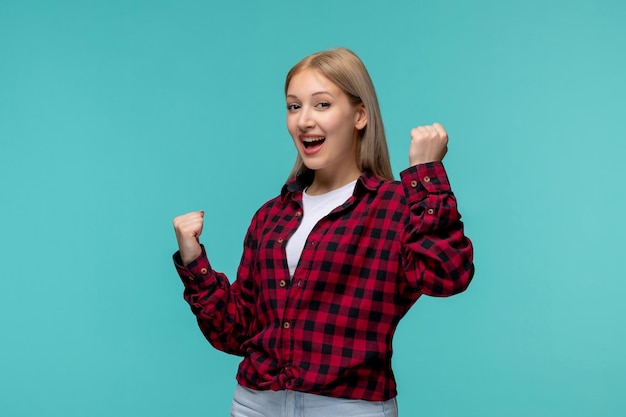 International students day excited lovely cute girl in red checked shirt holding fists up