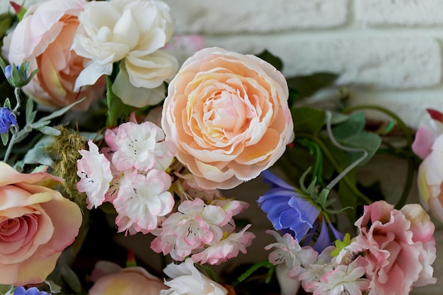 Intertwined flowers peonies decorating the interior White brick wall