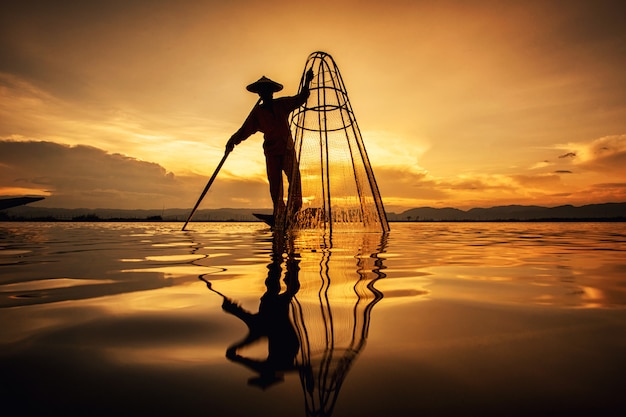 Intha Burmese fishermen on boat catching fish traditional at Inle Lake, Shan State, Myanmar