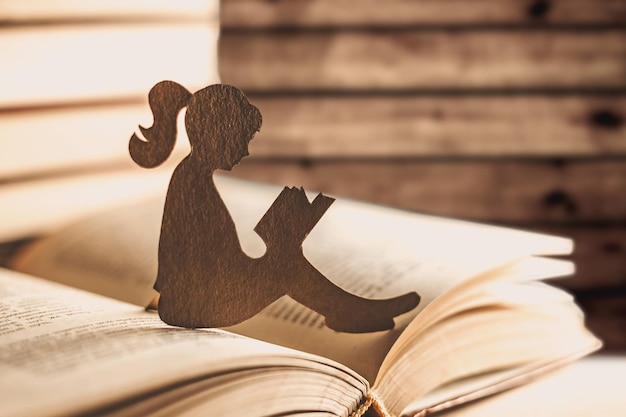 An introvert girl reads a bedtime story against the backdrop of books