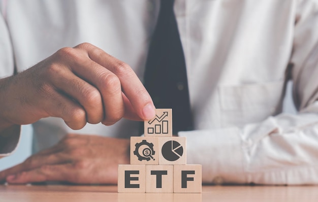 Investor holds the wooden cube with bitcoin icon standing with ETF text Entering the digital money fund ETF Exchange Traded Fund businessfinance conceptualxA