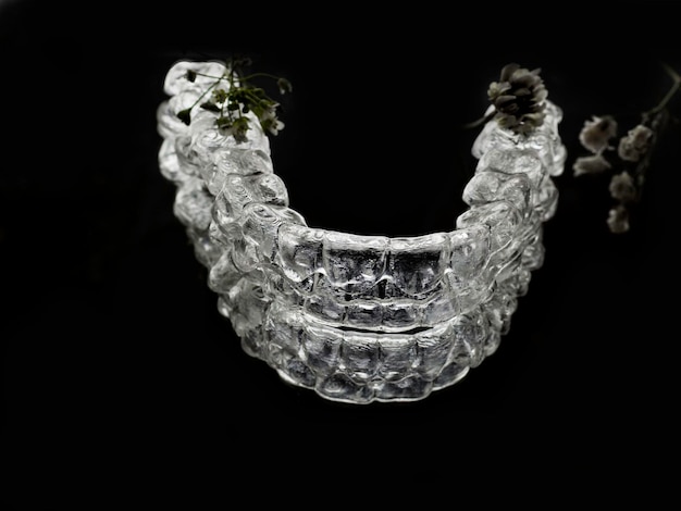 Invisalign braces or retainer isolated on black background