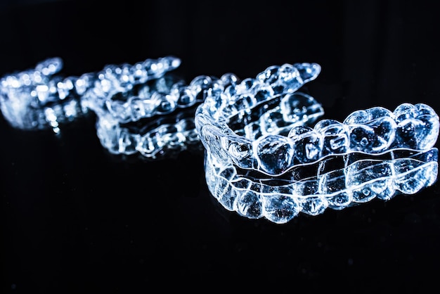 Invisible aligners teeth retainers lie on the mirror