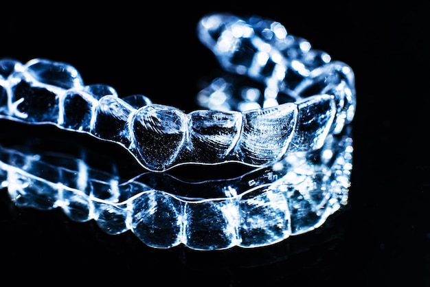 Invisible aligners teeth retainers lie on the mirror