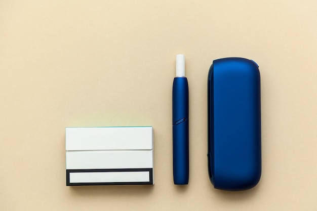 Iqos electronic blue cigarette on a beige background.