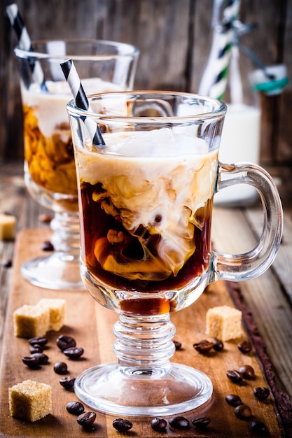 Irish coffee in mugs on wooden table