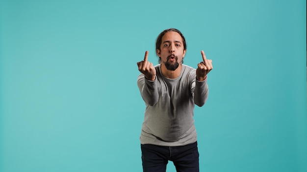 Irked man fighting with friend doing middle finger sign gesturing