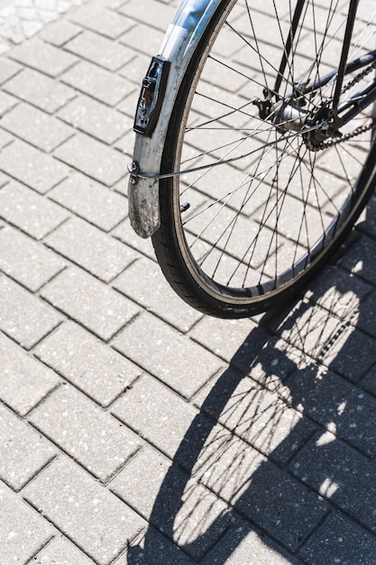 Iron road bicycle on a city street casting a shadow in the sunlight