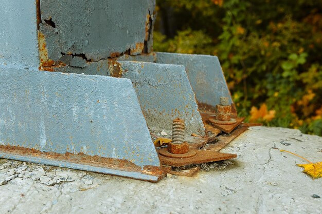 Iron structure attached to concrete with rusty bolts