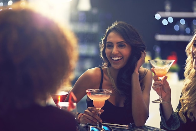 Is it time for another round yet Shot of a group of friends relaxing with cocktails in a nightclub